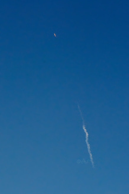 SpaceX Falcon midday rocket launch over hillside